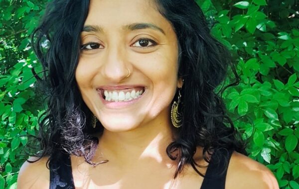 A headshot of Jilna smiling at the camera